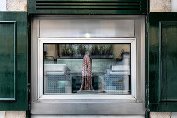 Octopus seen through the window of a tasca, traditional Portuguese restaurant