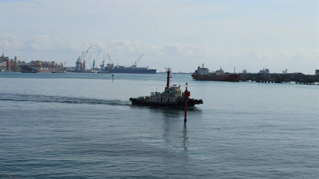 Tugboat Entering Port with Hyundai Heavy Industries in View