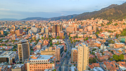 Aerial View of Bogotá's Urban Landscape at Sunset, Showcasing Modern and Traditional Architecture