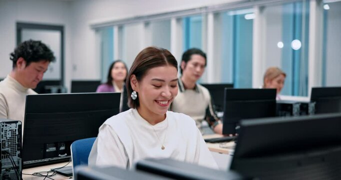 Japanese woman, students and computer science for learning, education and lesson in lab for degree. Group, people and classroom in university or college for skill, language and scholarship in school