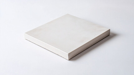 Fototapeta premium square white ceramic tile on a white surface