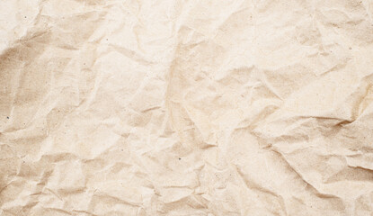 Recycled brown creased paper background from a paper packing. Crumpled brown paper texture concept