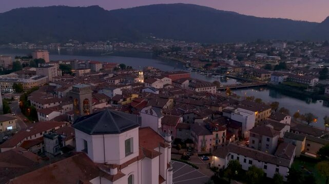 Flyng over San Martino church and the city of Sarnico Italy, iseo Lake