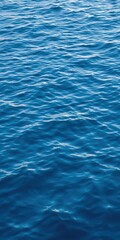 Rippling blue water surface with gentle waves, reflective