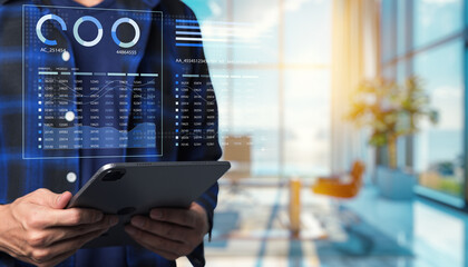 Business professional analyzing data on digital tablet in modern office environment, showcasing futuristic technology and business statistics in blurred background