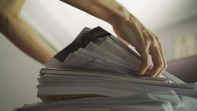A man stacking a pile of paperwork