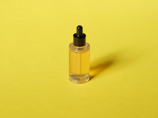 A bottle of ampoule on a yellow background
