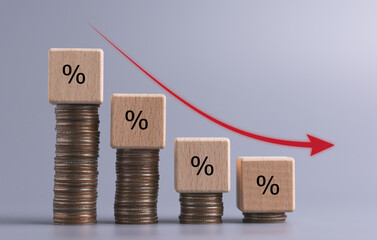business turnover decreased, interest rate decline, Wood blocks with percentage sign and down arrow on color background, recession crisis concept.	