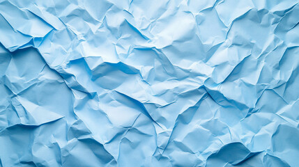 Obraz premium Crumpled blue paper with intricate textures and folds creating an abstract background