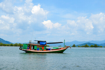 Fototapeta premium Local fishing boats in southern Thailand. Floating, waiting for the tide to rise so they can go fishing the next day.