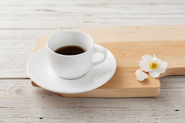 Cup of hot cappuccino coffee on table.