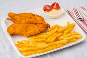 Deep fried chicken fillet. Served with fries and sauces. Delicious chicken.