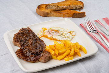 Tenderloin meat portion. Nicely cooked, juicy and delicious tenderloin meat with sauce. Accompanied by French fries and sauce.