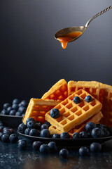Belgian waffles with fresh blueberries and caramel sauce.