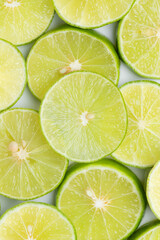 Slice of green lime on white background. Top view