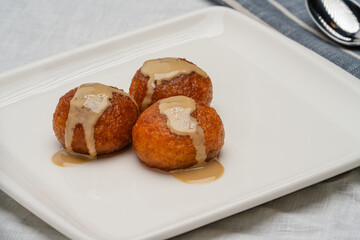 Kemalpasa Dessert (Cheese dessert) is garnished with tahini. It is a traditional Turkish dessert.