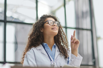 working at psychology clinic pointing with hand finger to the side showing advertisement