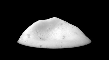 Liquid white foam from soap or shampoo or bath bubbles. Abstract soap bubbles. Soap bubbles set. Soap bubbles isolated on black with texture and contrast background.