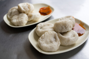 Delicious steamed buns on white plates