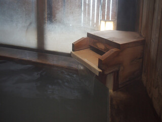 Japanese onsen hot spring wooden fountain with flowing water