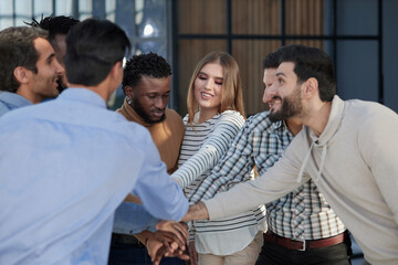 Happy colleagues welcome businessman to their successful team