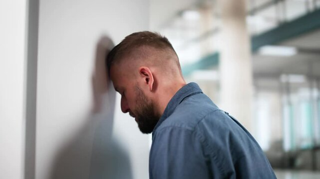 Sad Man Head Against Wall