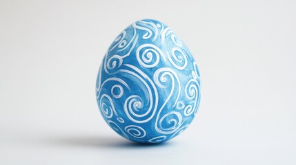 Beautifully Hand-Painted Blue Egg with Intricate White Swirl Patterns on a Light Background, Perfect for Celebrating Spring Festivals and Easter Designs