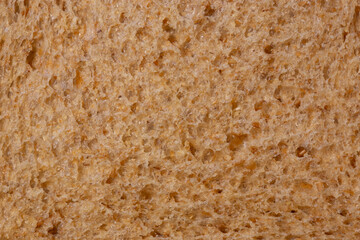 Slice of wholemeal brown bread background backdrop close up. Healthy food diet concept.