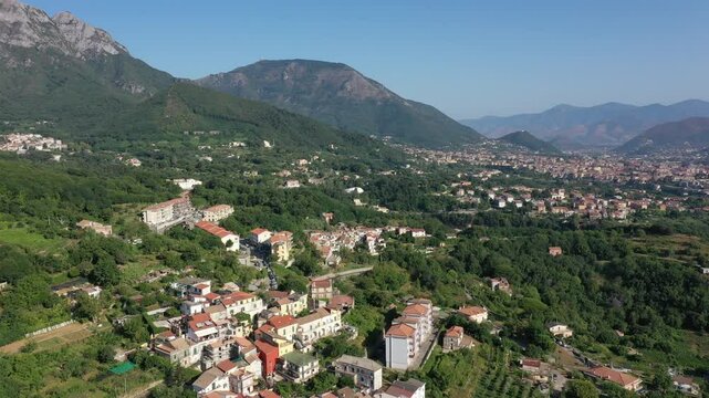 Aerial view from high altitude of rocky mountains and houses on hills near Vietri Sul Mare on a sunny summer day, Raite, Salerno, Italy
