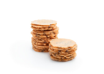 Stack of thin round crispbreads with herbs isolated on white