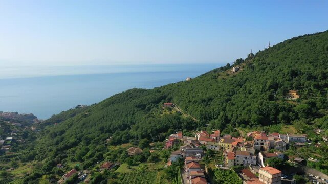 Aerial view from high altitude of rocky mountains and houses on hills near Vietri Sul Mare on a sunny summer day, Raite, Salerno, Italy