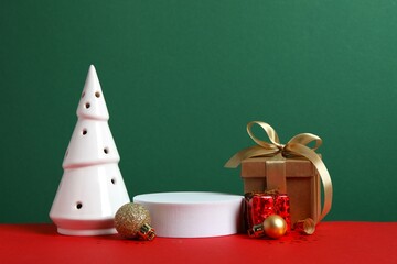 Beautiful composition with podium and Christmas decor on two-tone background