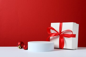 Beautiful composition with podium and Christmas decor on two-tone background