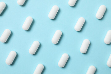 White medicine pills on a color background