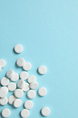 White medicine pills on a color background