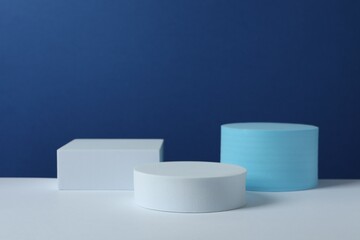 White podiums on color background 