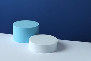 White podiums on color background 