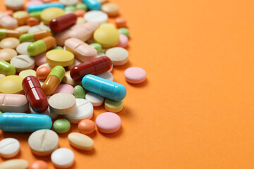 Medicine pills and capsules on a color background