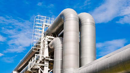 pipeline close-up against blue sky and clouds view from below