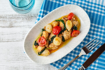 Appetizer with shrimps, onions and tomatoes on a white porcelain plate