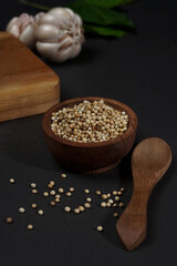 White peper in wooden bowl isolated on black background. High resolution photo.