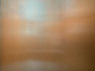 Texture of matt golden bronze fluted glass, or striped glass. Fluted glass is aesthetically beautiful in interior finishes and used for doors and partition. Seamless fluted glass panel.