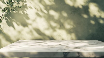 White marble tabletop with beige stucco wall and green shadows