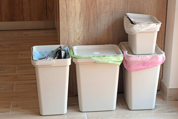 Separate sorting of garbage at home. Colorful bags and containers. Ecology and safe waste. 