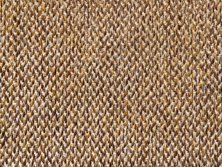 Close up texture of golden brown upholstery fabric, made of cotton and polyester knitted and woven. Suitable for cushion and curtain drapery. Seamless background fabric texture.