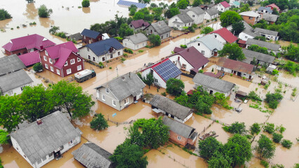 Fototapeta na wymiar Aerial View of Flooded Residential Neighborhood. Aerial image showing a flooded residential neighborhood with homes and gardens submerged after a severe rainfall, highlighting environmental disaster.
