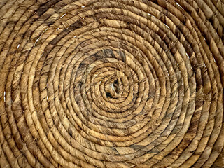 Random spiral rattan or wicker art and craft, round circle spiral synthetic rattan basket weave accessories or decoration on wall.