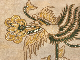 Random texture of custom bespoke carpet rug design, in various bird, trees, branches, flower, and wavy pattern. Beige, red, and gold color. Luxurious seamless background carpet texture.