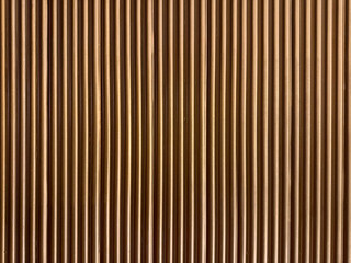 Fluted wood strips panel finished in golden metallic spray paint, a luxurious touch for seamless...