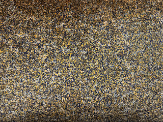 Golden dark bronze dotted rough random fabric suitable for bedding or pillow cover. Seamless red background texture.